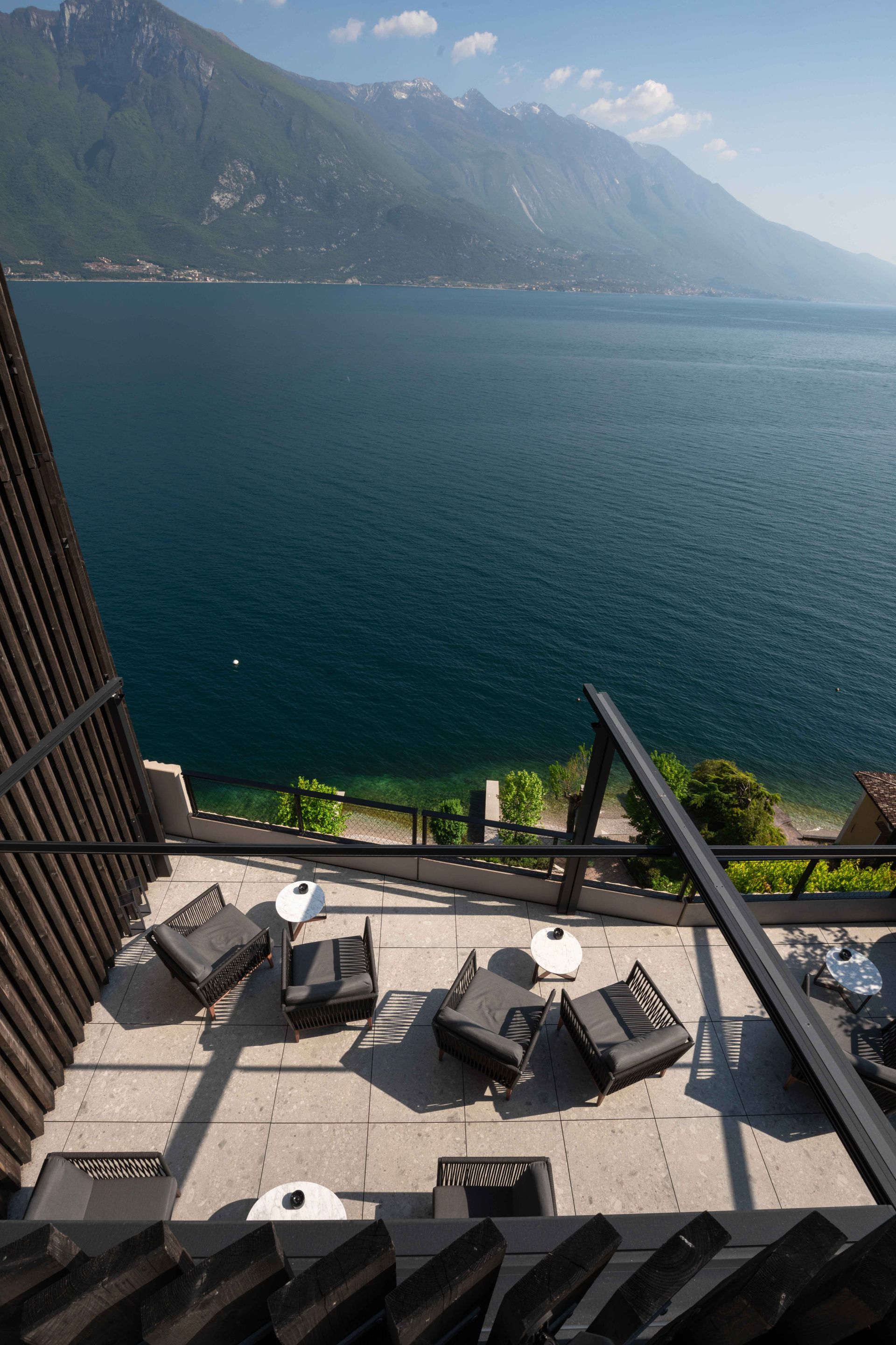 A balcony overlooking a lake with mountains in the background - Freehold, NJ - Awning Design Inc