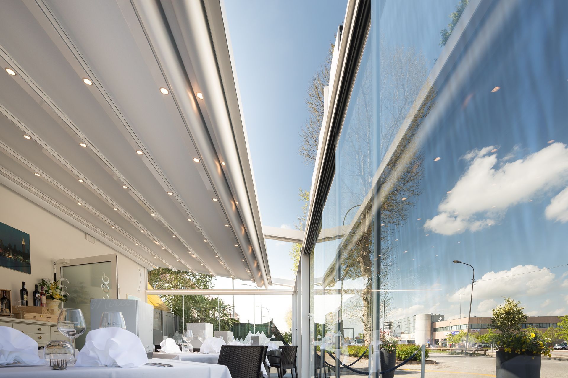 A restaurant with tables and chairs and a large window - Freehold, NJ - Awning Design Inc