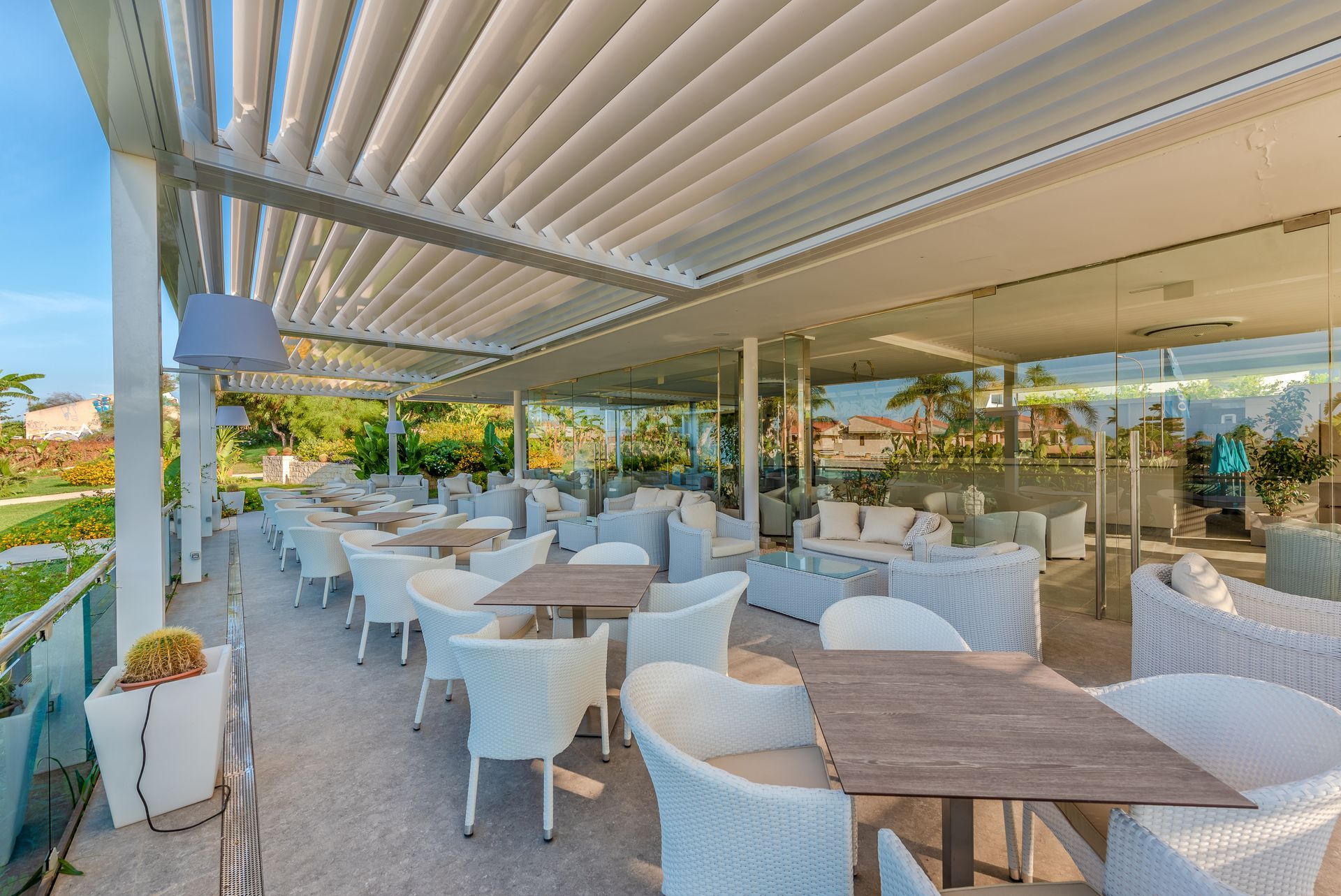 A restaurant with tables and chairs under a pergola - Freehold, NJ - Awning Design Inc