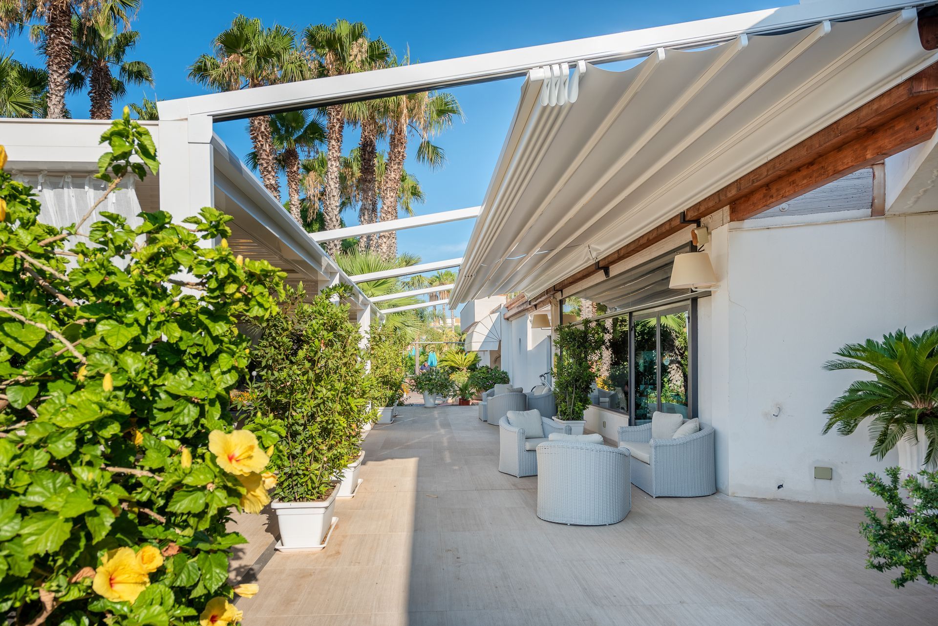 A patio with chairs and a canopy over it - Freehold, NJ - Awning Design Inc