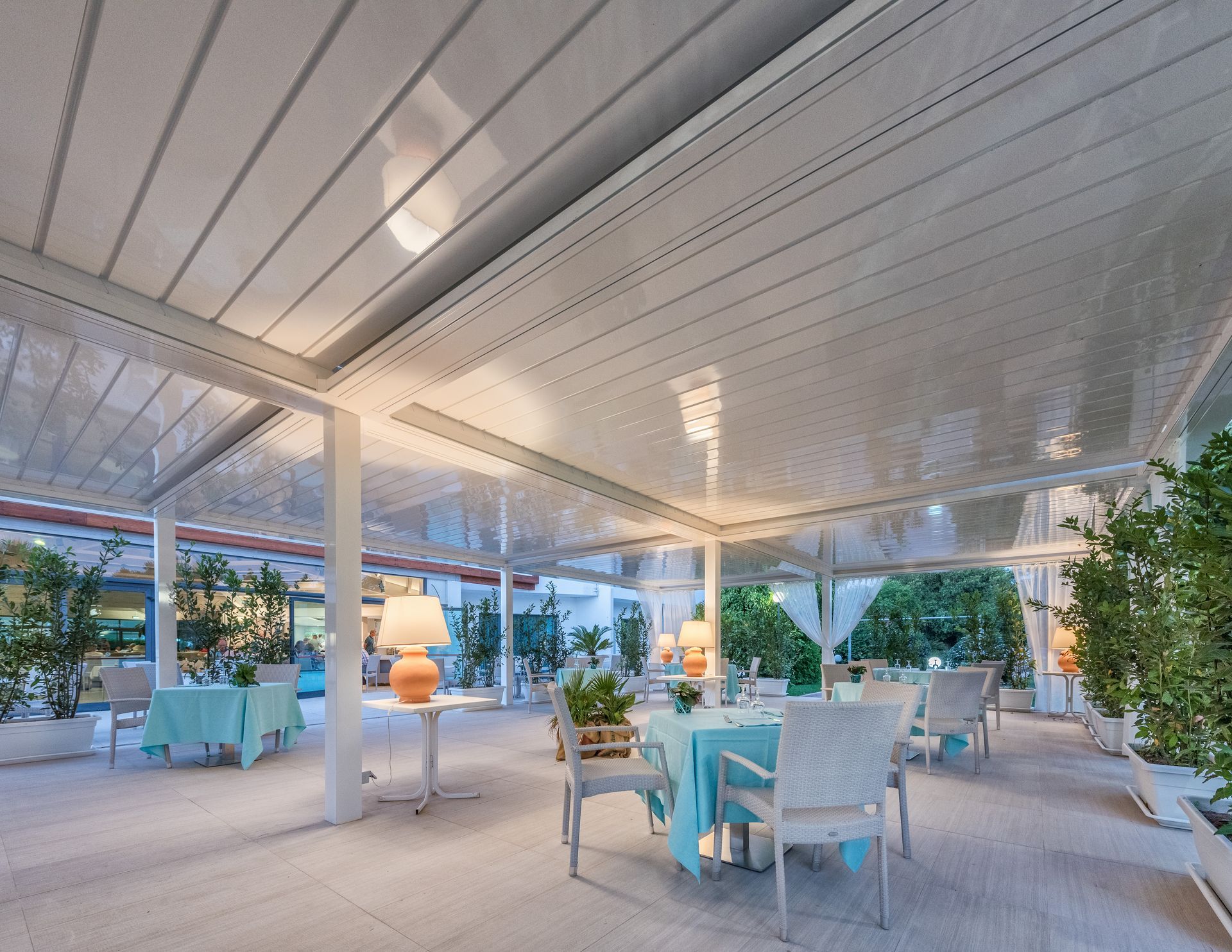 A large room with tables and chairs under a canopy - Freehold, NJ - Awning Design Inc