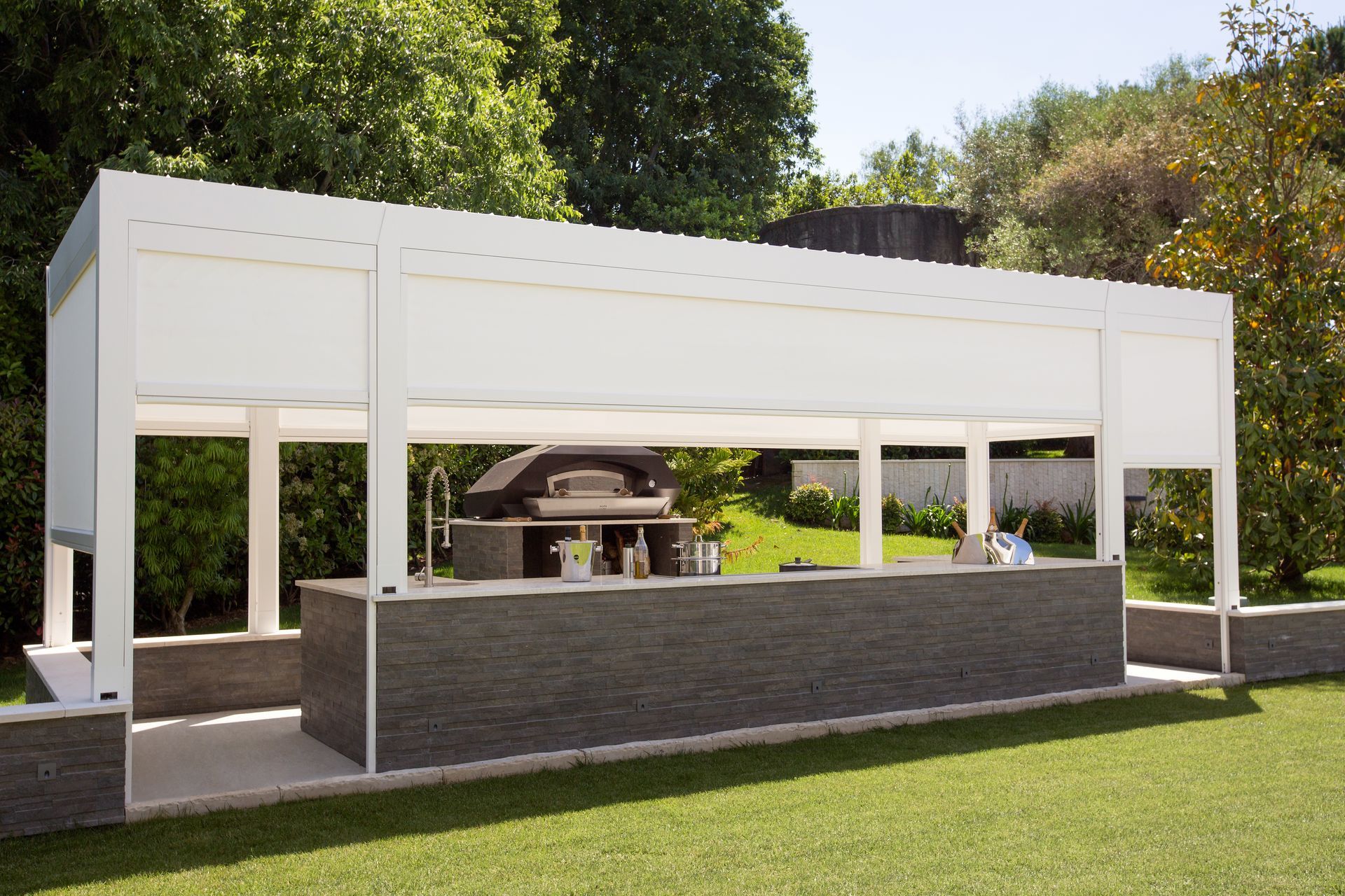 A large white structure in the middle of a lush green field - Freehold, NJ - Awning Design Inc