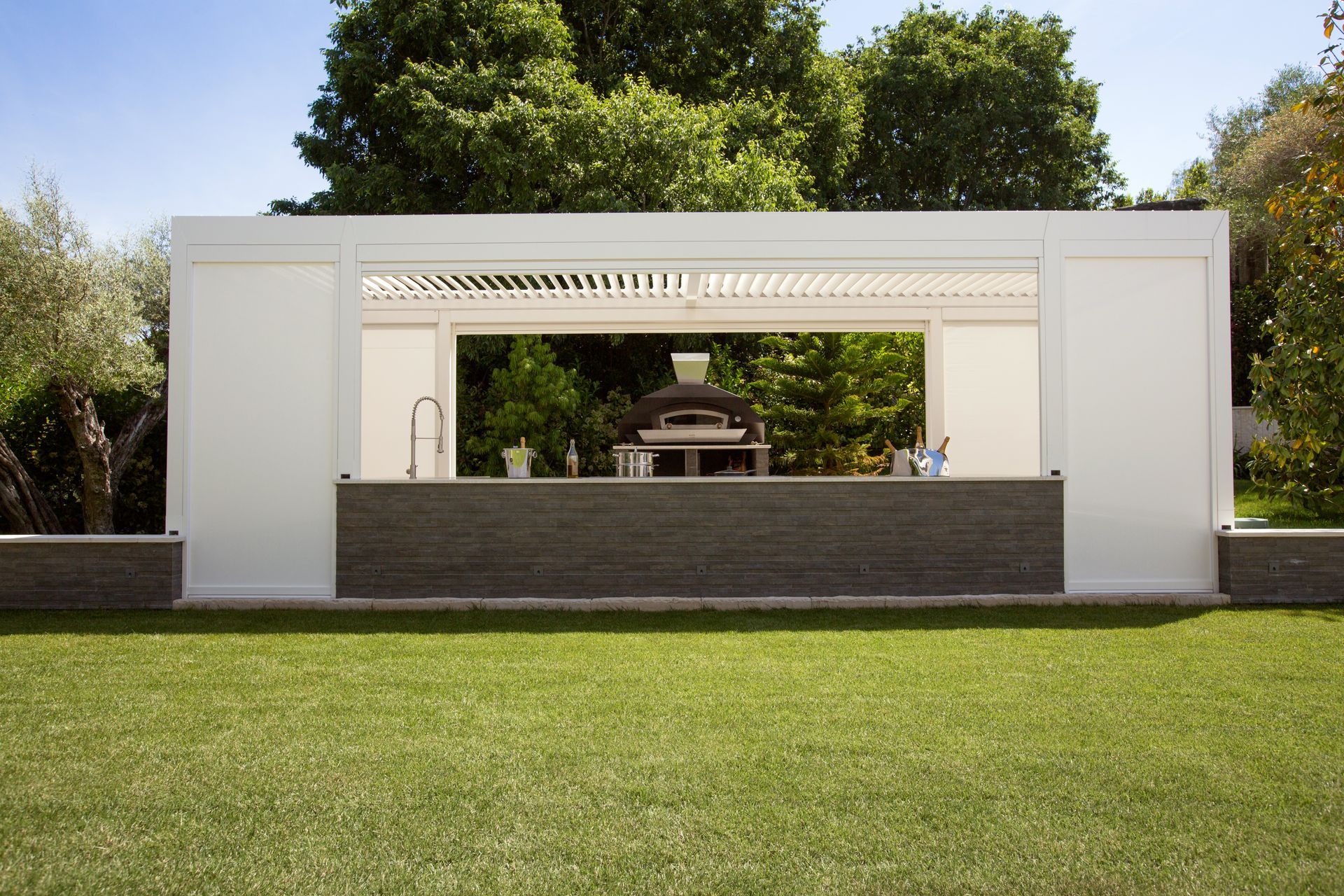 A large white building is sitting in the middle of a lush green field - Freehold, NJ - Awning Design Inc
