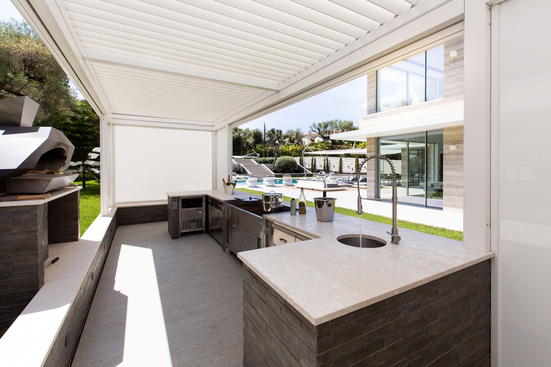 A kitchen with a sink and a pizza oven - Freehold, NJ - Awning Design Inc