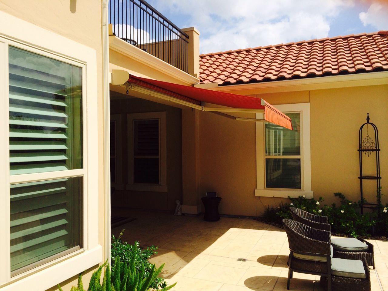 A house with a red awning on the side of it - Freehold, NJ - Awning Design Inc