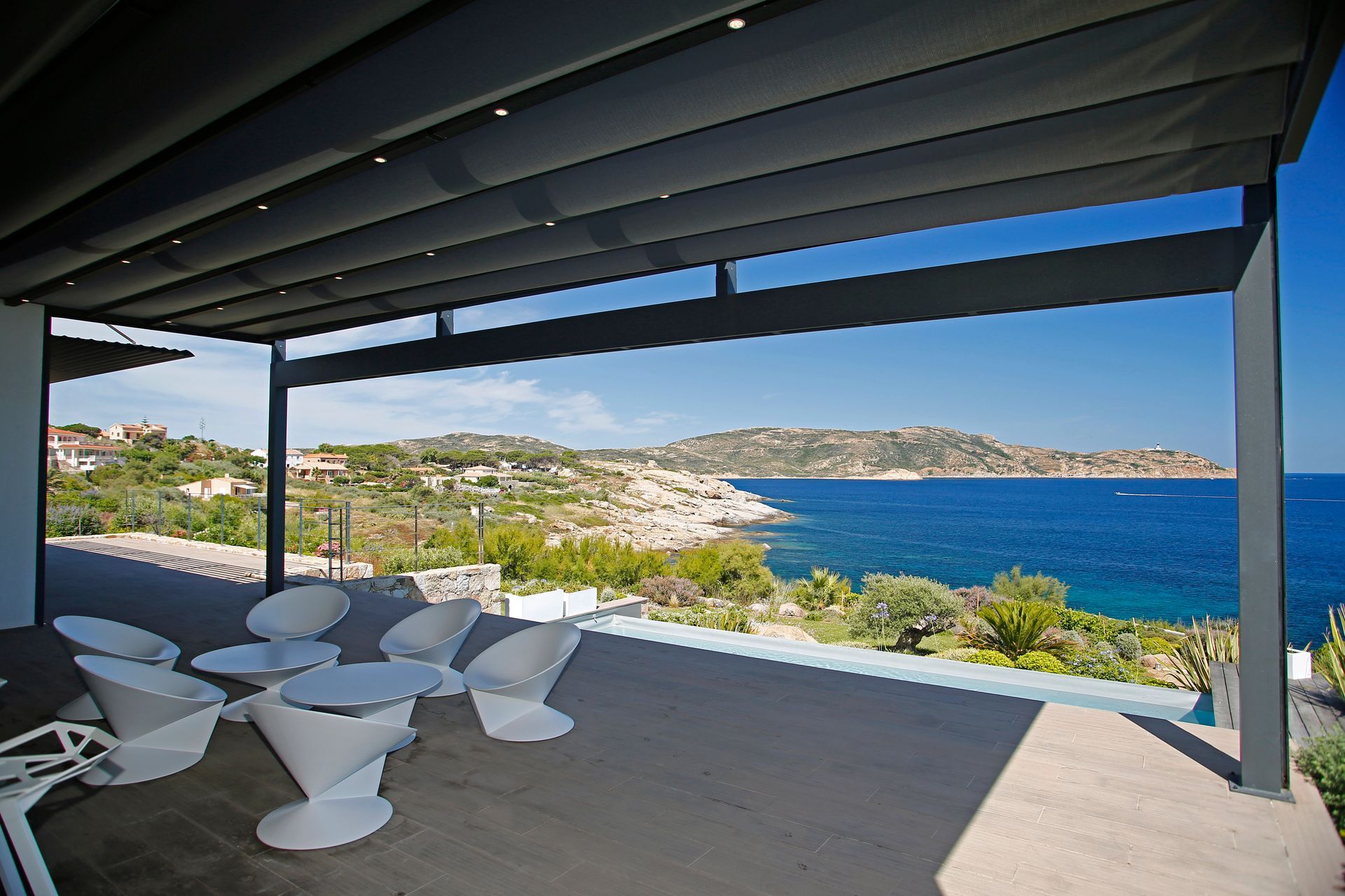A patio with tables and chairs overlooking the ocean - Freehold, NJ - Awning Design Inc