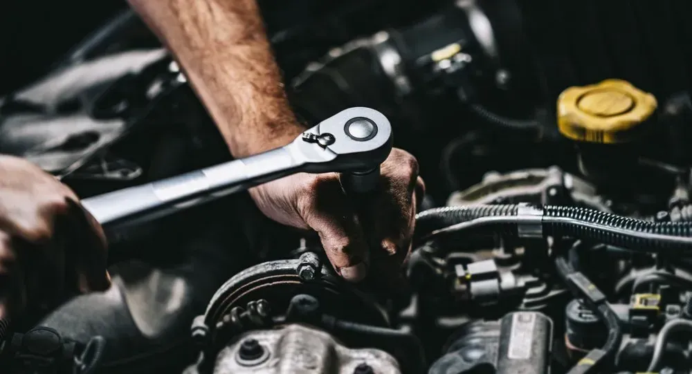 Mechanic's Hands Using a Wrench on a Car Engine  — B Wild Auto Repairs In North Gosford, NSW