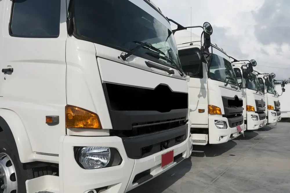 Line of White Semi-trucks Parked Outdoors on a Cloudy Day  — B Wild Auto Repairs In North Gosford, NSW