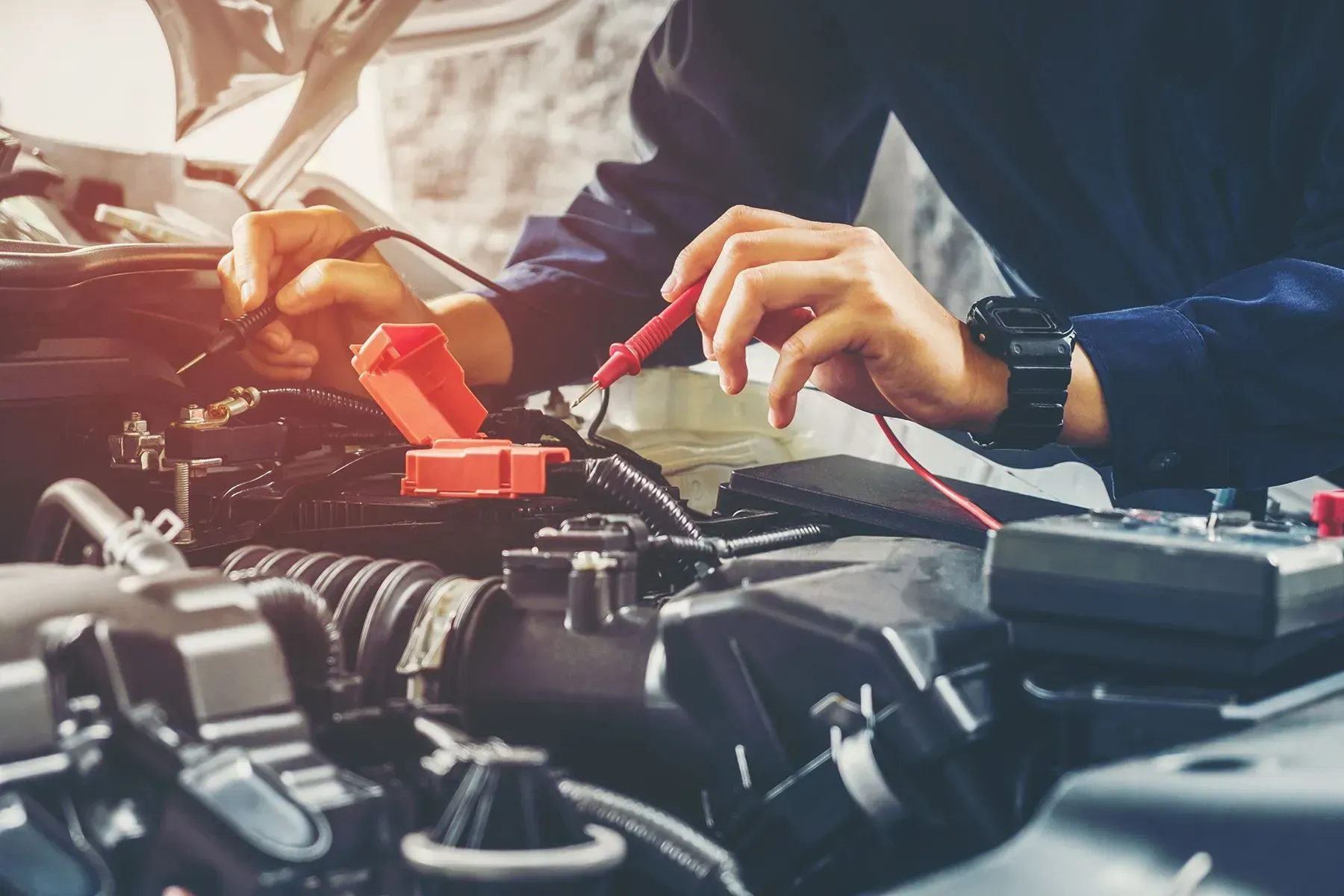 Mechanic Using Multimeter to Test Car Engine Wires  — B Wild Auto Repairs In North Gosford, NSW