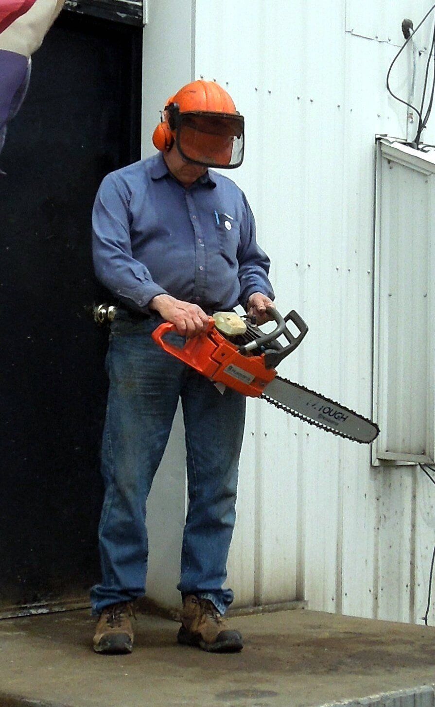 man holding chain saw