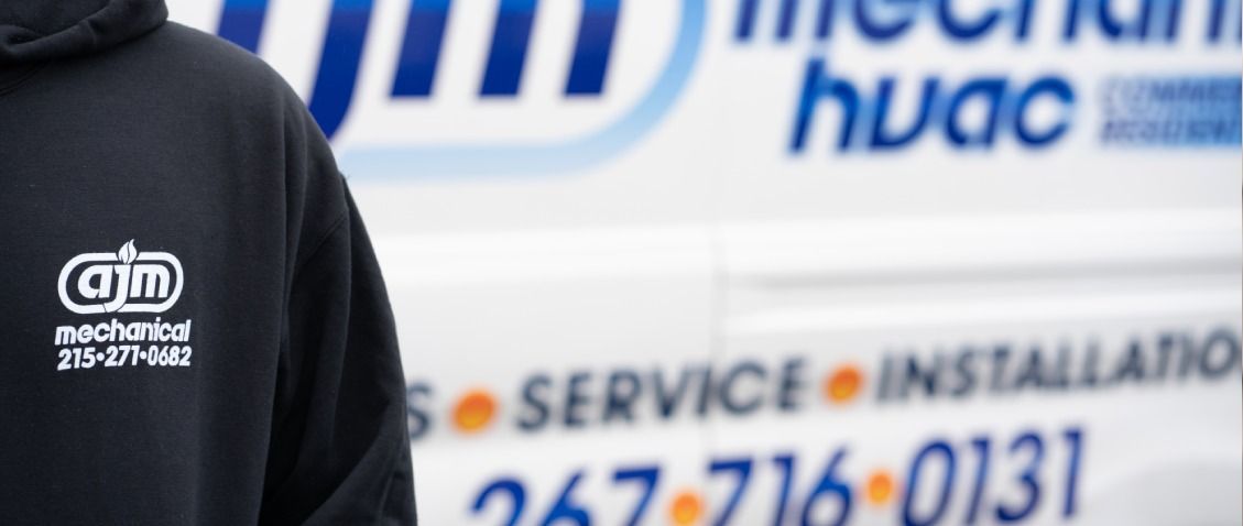 Person in black hoodie with logo 