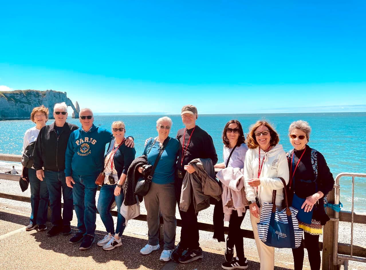 Woman in a hat looking at the Eiffel Tower, Paris, France, on a sunny day.