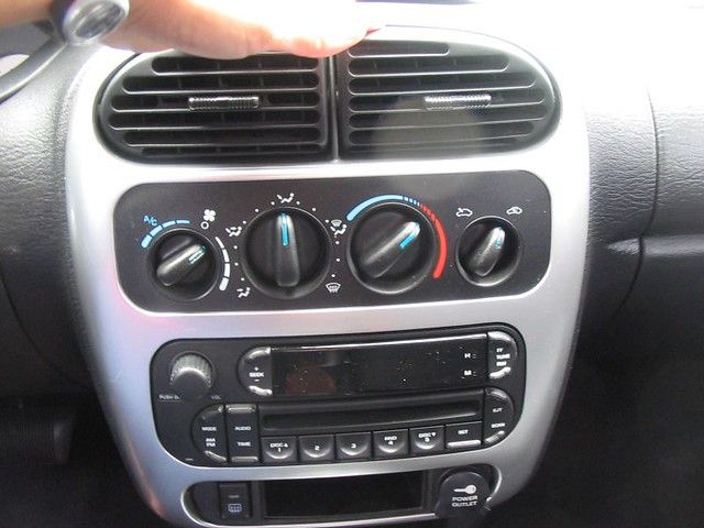 A person is adjusting the climate control in a car
