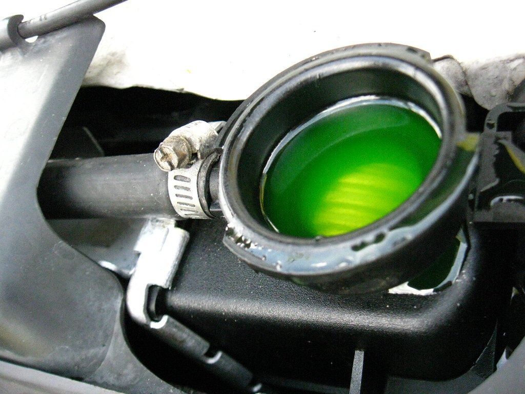 A green liquid is coming out of a radiator