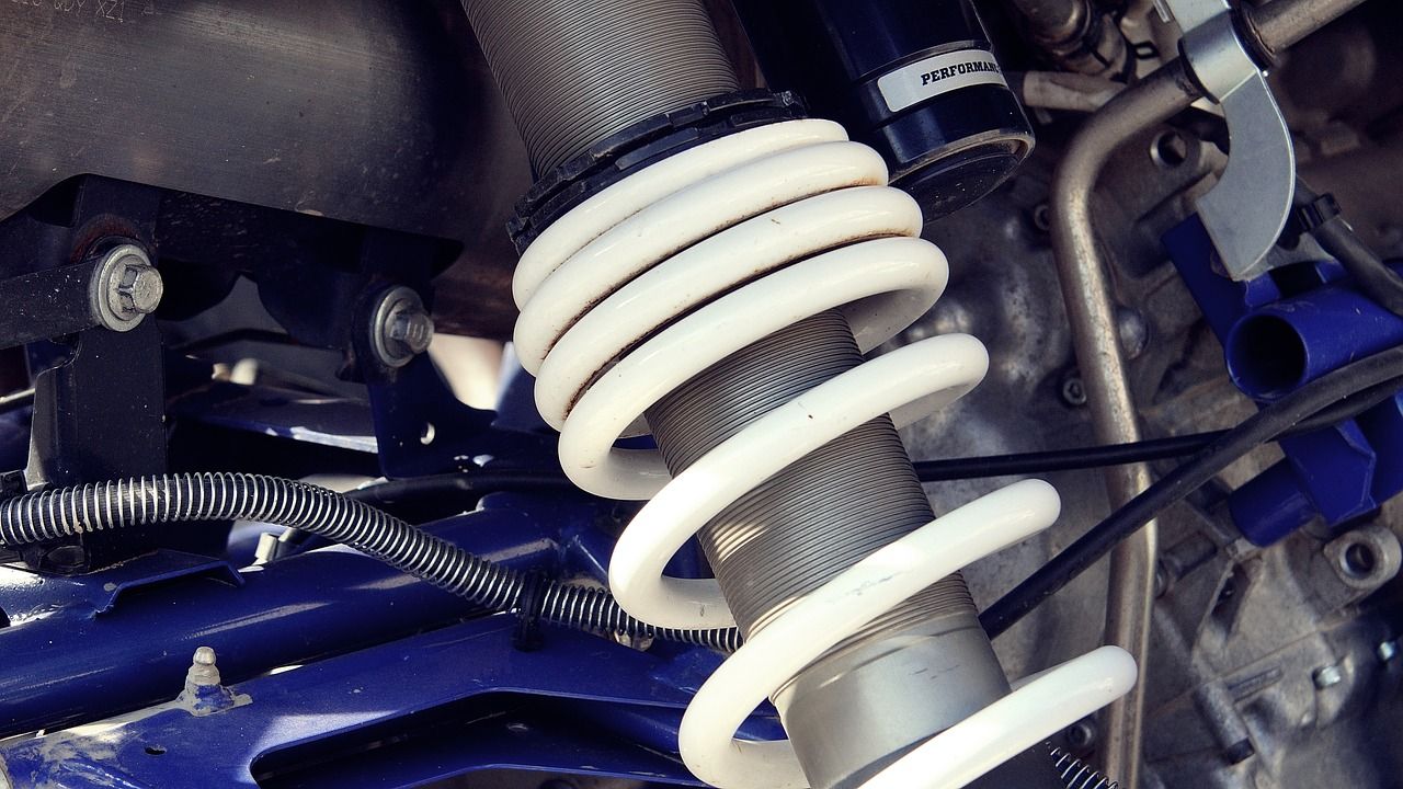 A close up of a shock absorber on a vehicle.