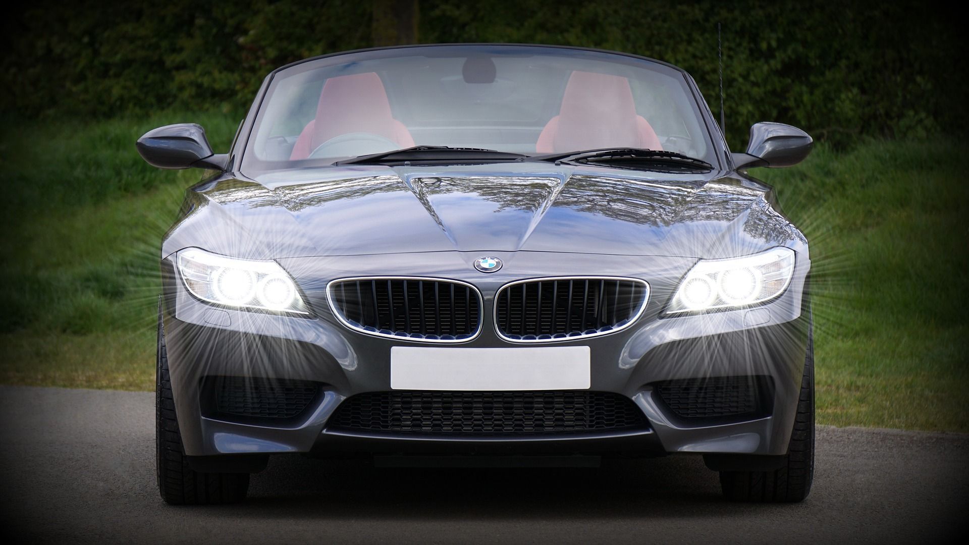 The front of a bmw z4 is parked on the side of the road.