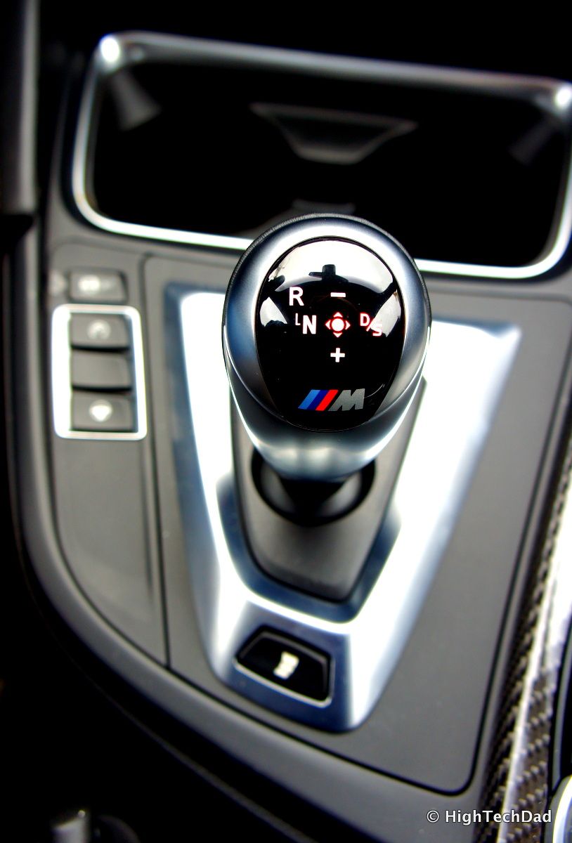 A close up of a car shifter with the letter m on it