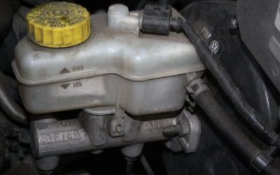 A close up of a brake fluid reservoir in a car.