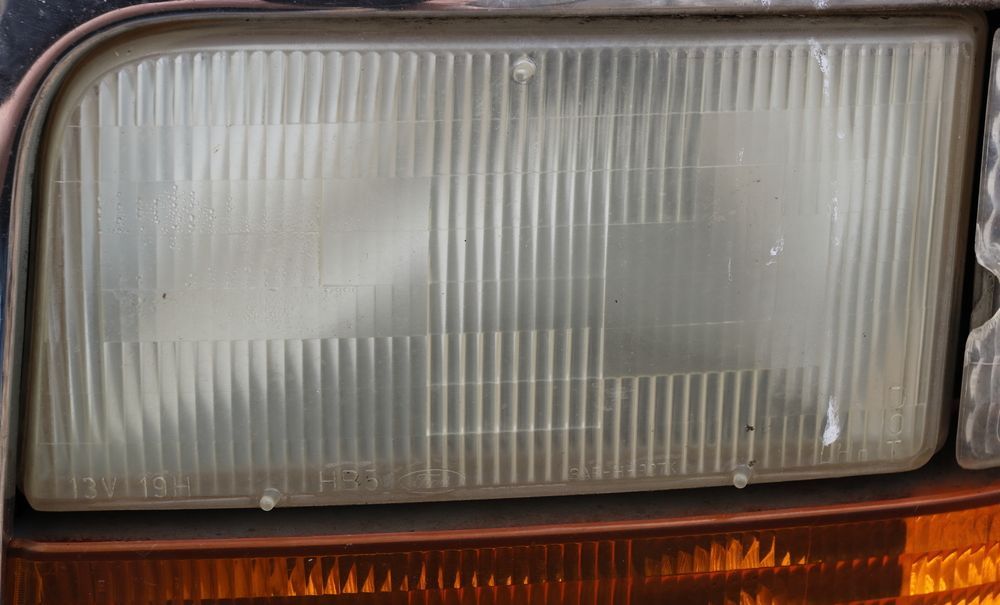 A close up of a headlight on a car.