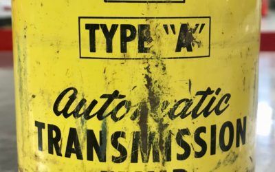 A yellow can of type a automatic transmission oil is sitting on a table.