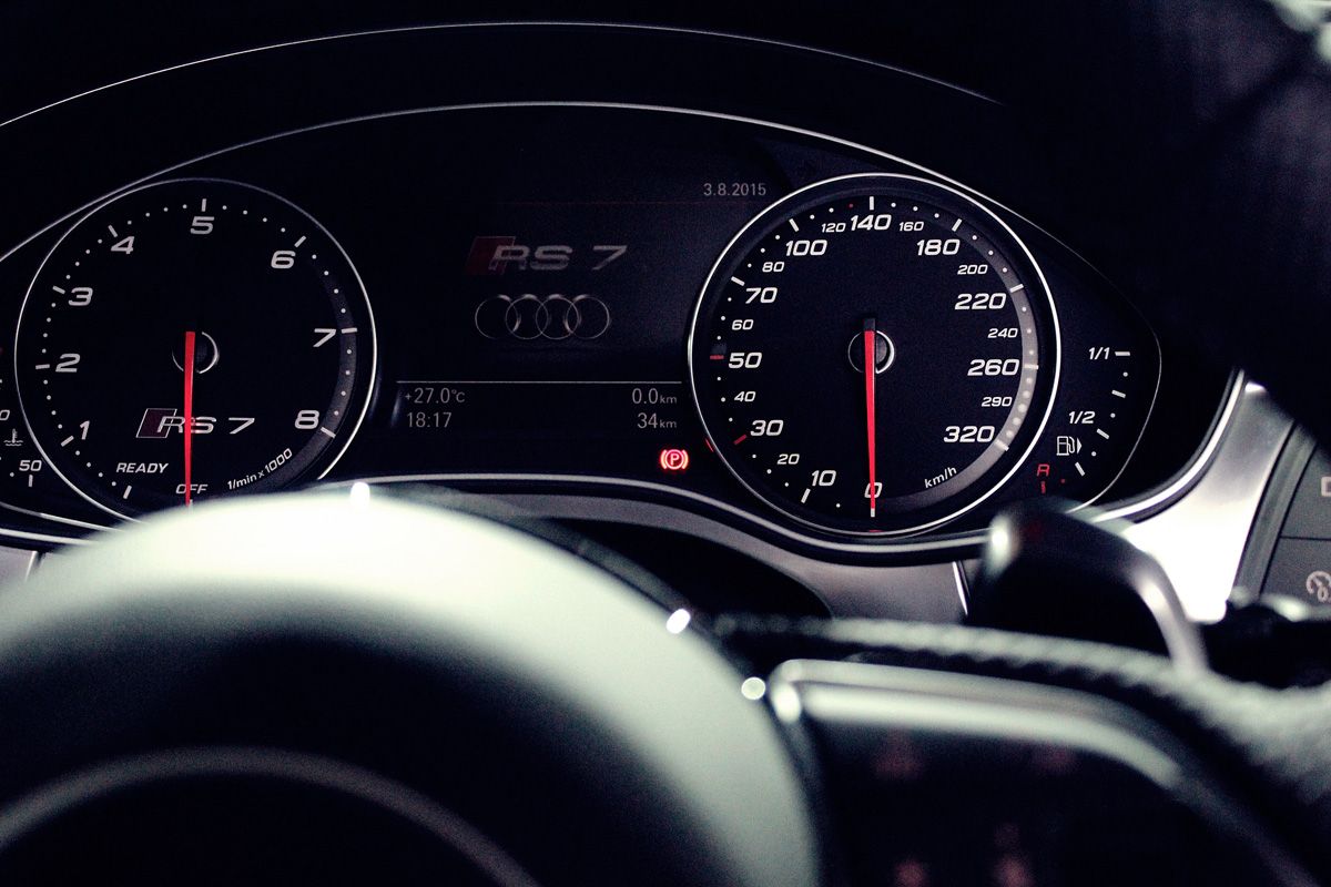 A close up of a car 's dashboard and steering wheel
