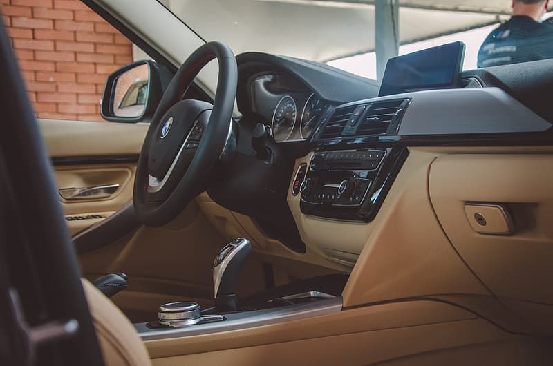 The interior of a car with a steering wheel and dashboard.