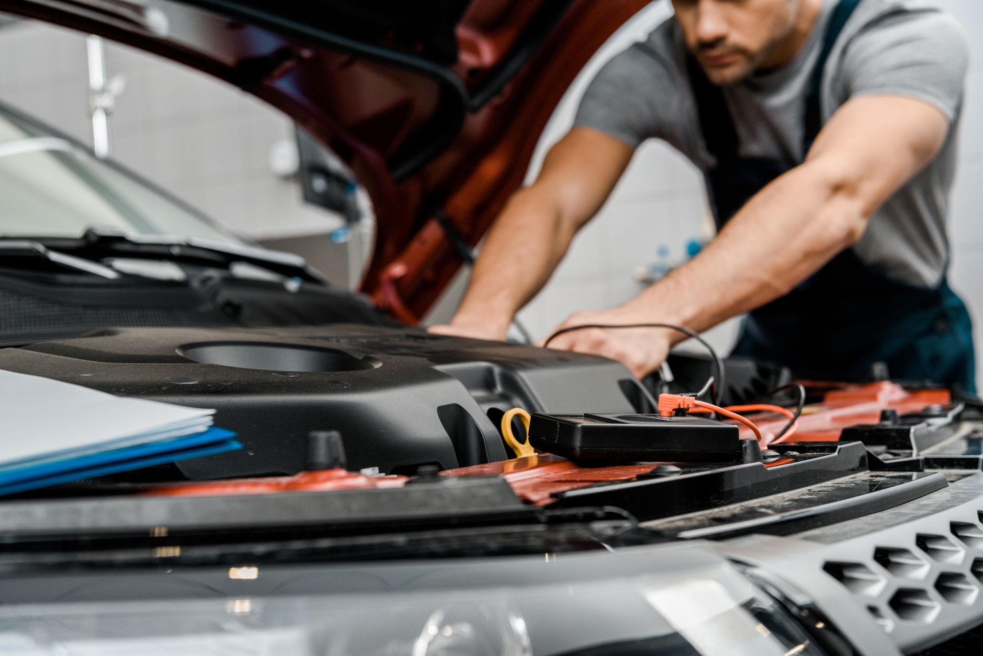 A man is working on the engine of a car.