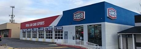 A large blue and white building with a red and white awning.