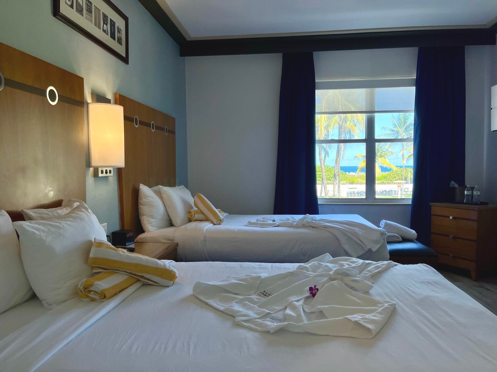 A hotel room with two beds , a desk and chairs.