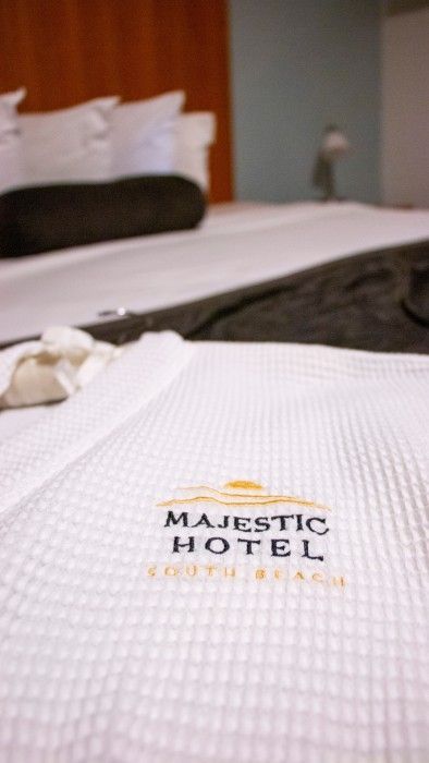 A bed with a towel that says majestic hotel on it