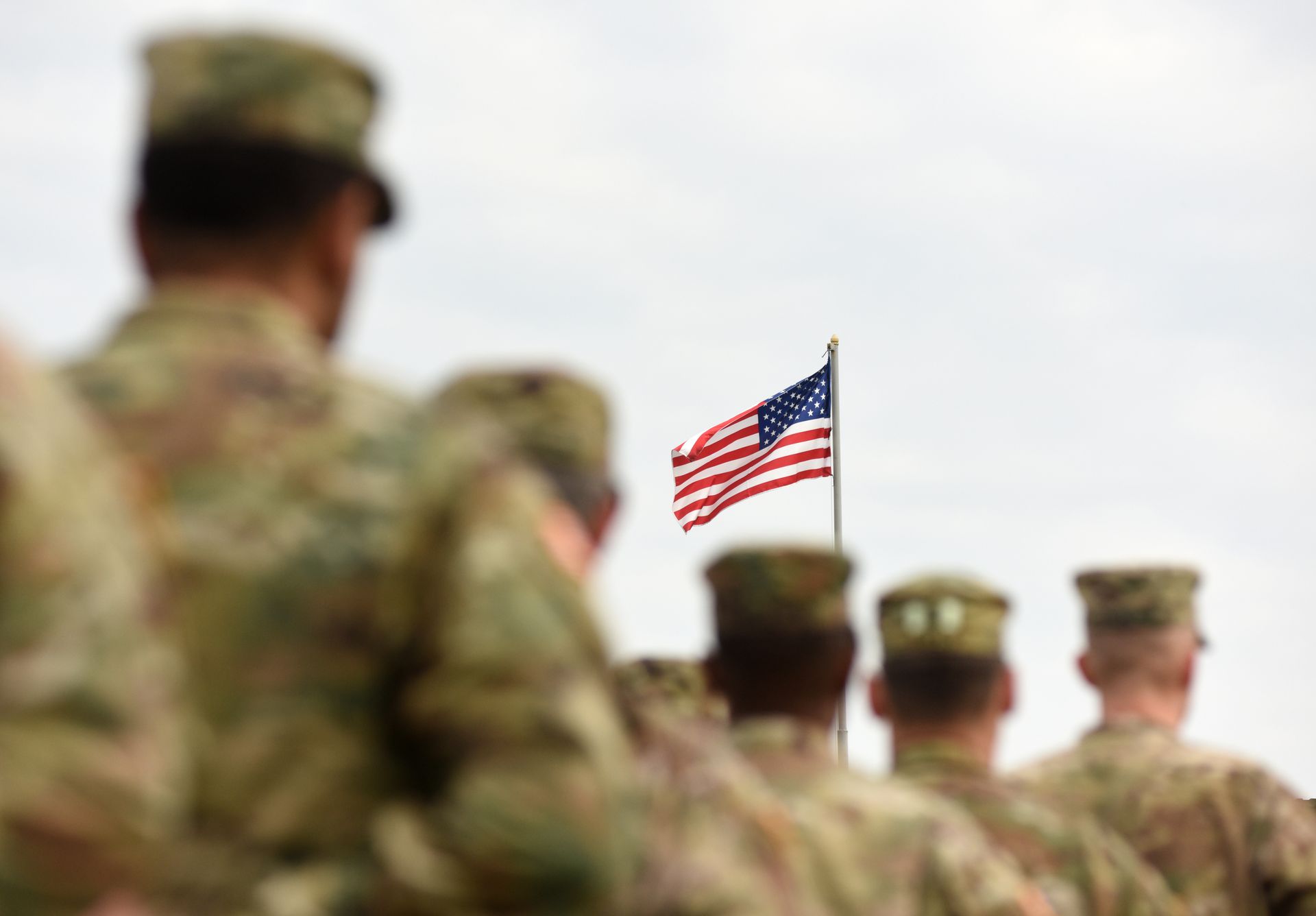 Soldiers In Front Of The American Flag
