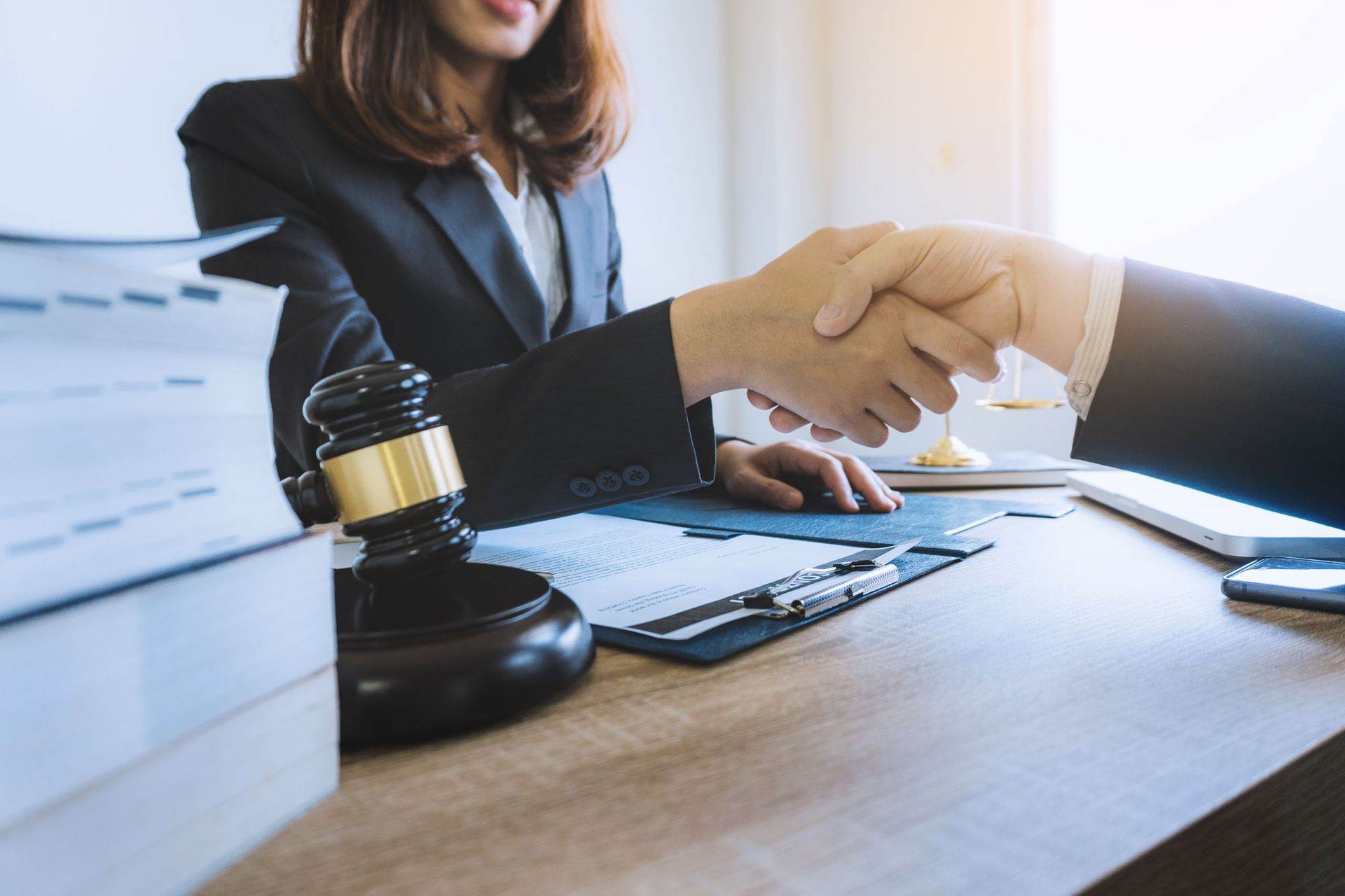 Handshake of lawyer in a lawyer's office after counseling and giving advice between business man customer