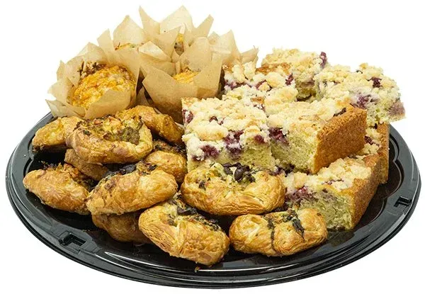 Assorted pastry platter with muffins, danishes, and crumb cake on a black tray.