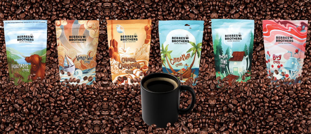 Six coffee bags with different colorful designs, a black coffee mug, all surrounded by coffee beans.