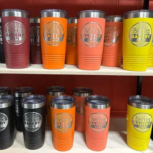 A shelf of colorful insulated tumblers from