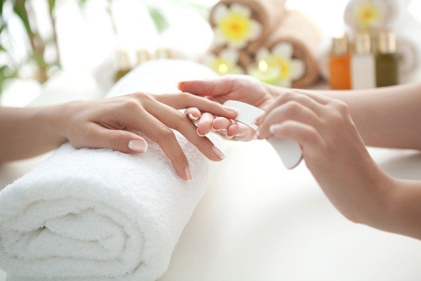 Close up of beautiful female hands having manicure treatment