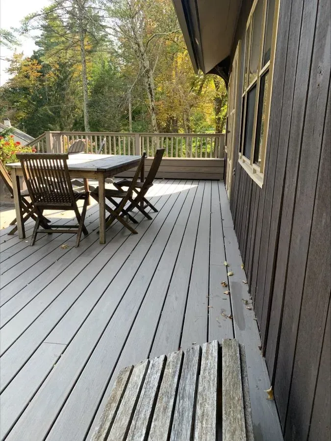 A wooden deck with a table and chairs on it