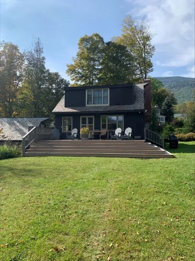 A large house with a large deck in front of it.