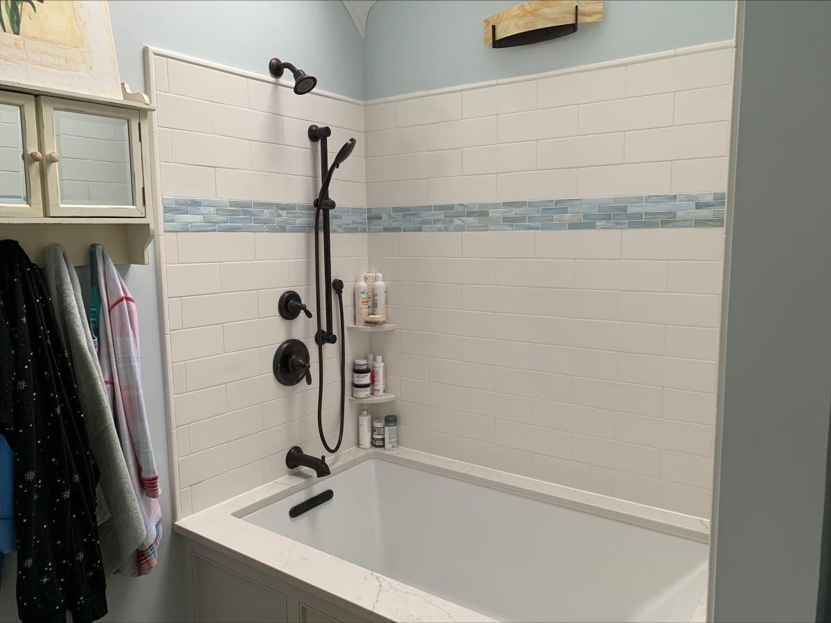 A bathroom with a bathtub and a shower.