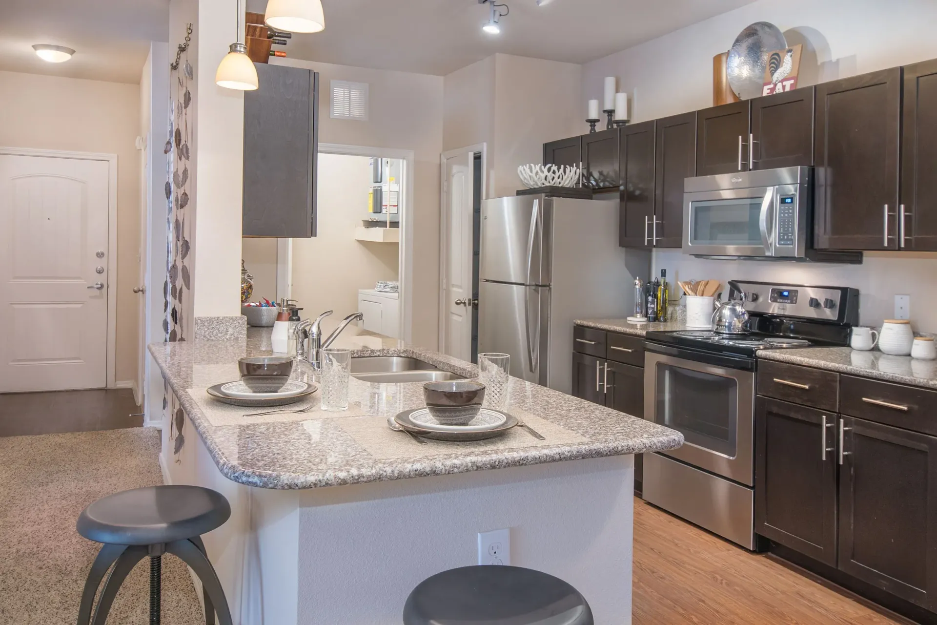 Open kitchen with granite counters, stainless appliances, and a center island.
