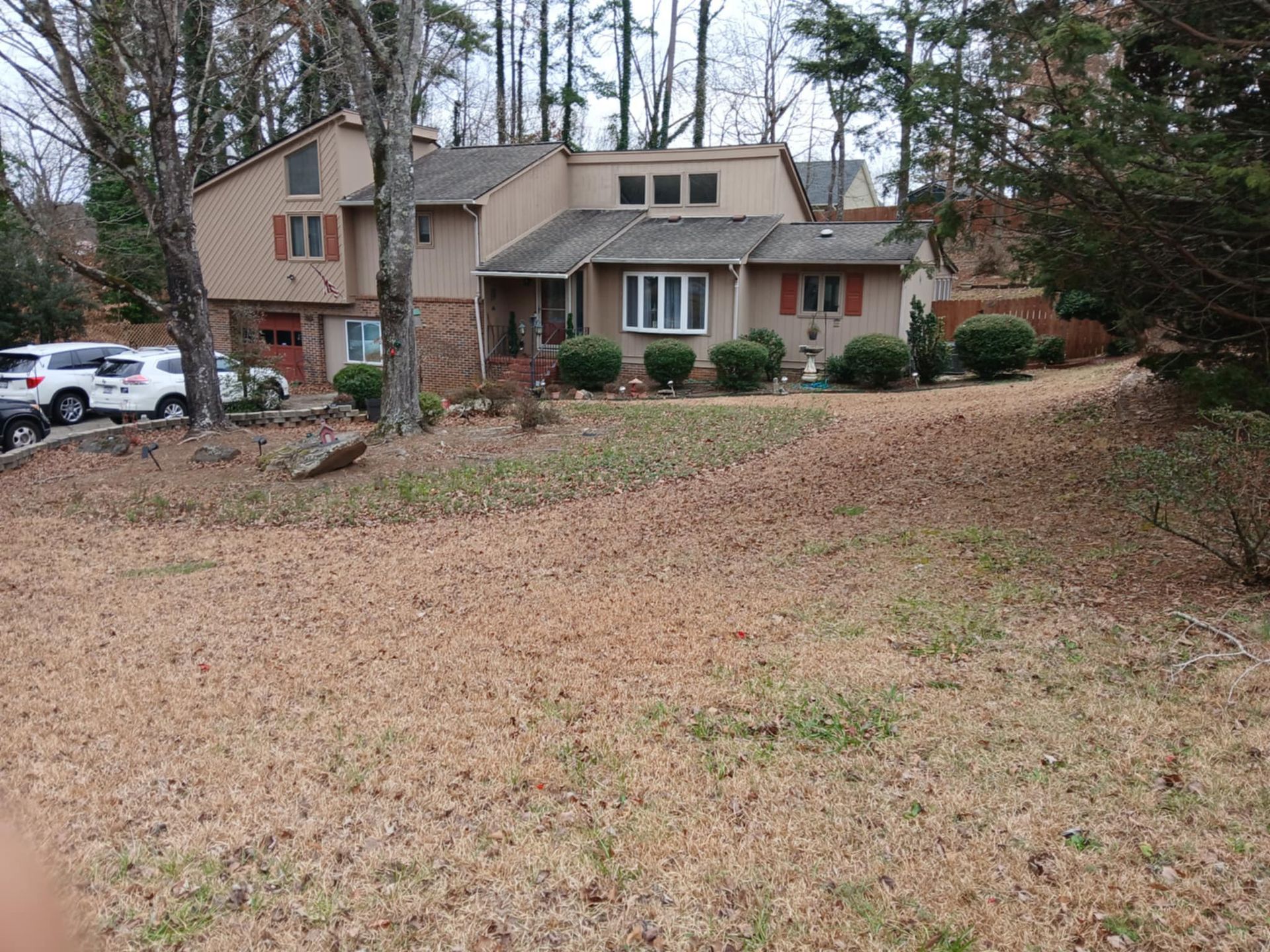 A house with a lot of leaves on the ground