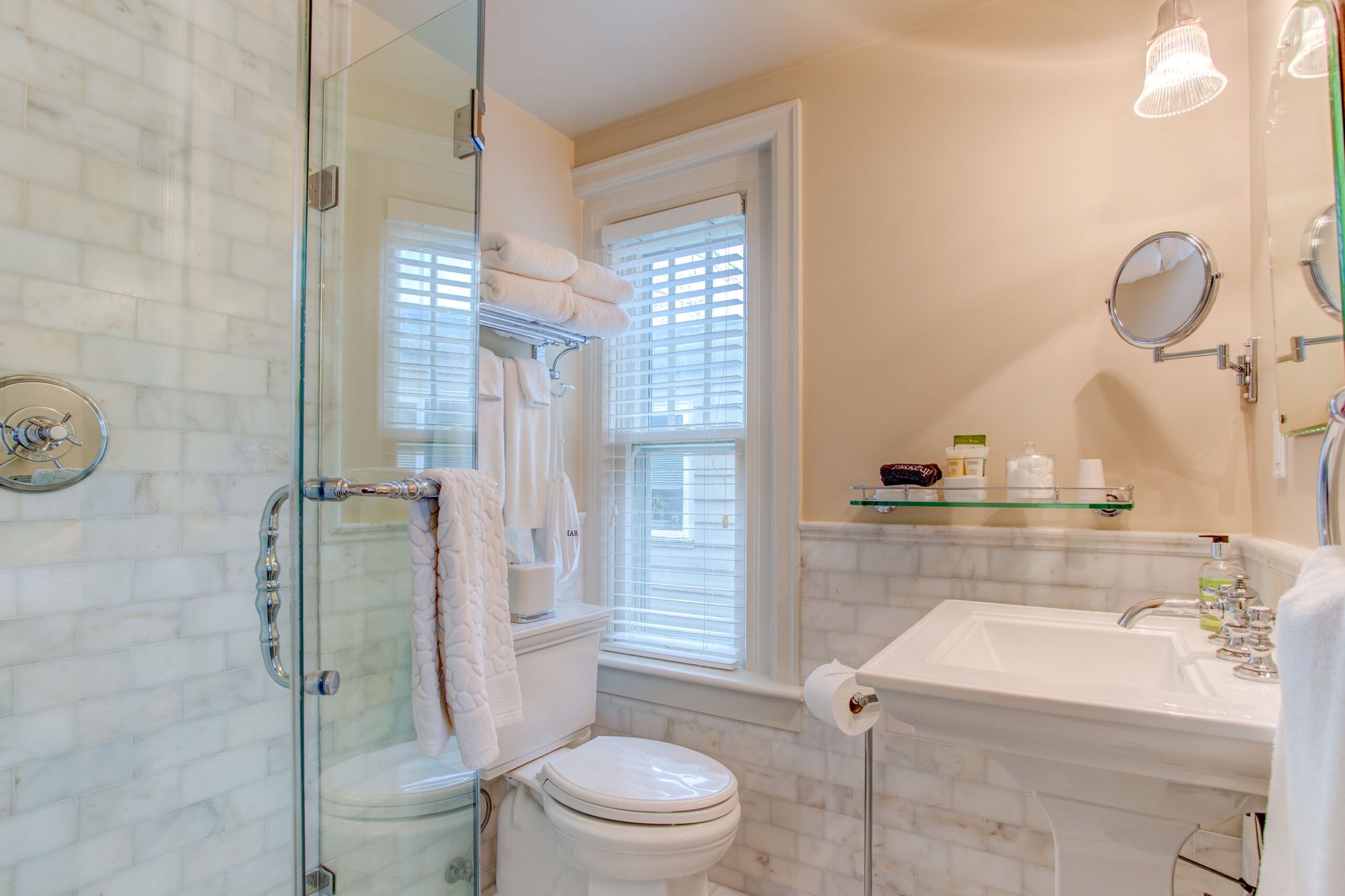 A bathroom with a toilet , sink , and shower.