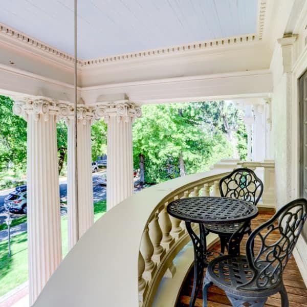 A balcony with a table and chairs on it