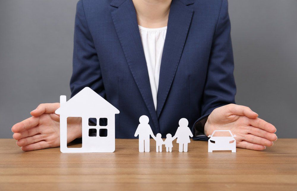 Woman with cutout paper family — Insurance Services in Yeppoon QLD