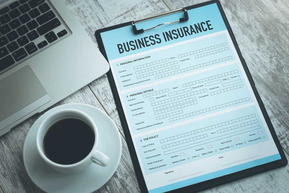Business Insurance Form with Coffee — Insurance Services in Biloela QLD