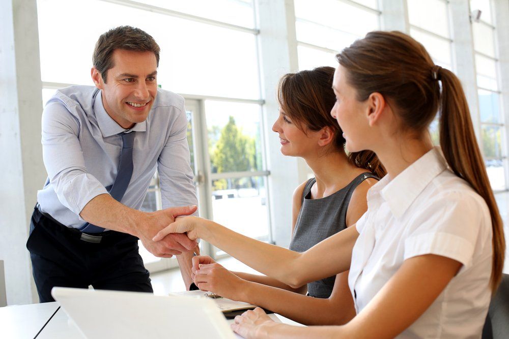 Businessman Shaking Hands with Client — Insurance Services in Rockhampton, QLD