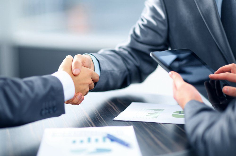 Men Shaking Hands Over Business Deal — Insurance Services in Rockhampton, QLD