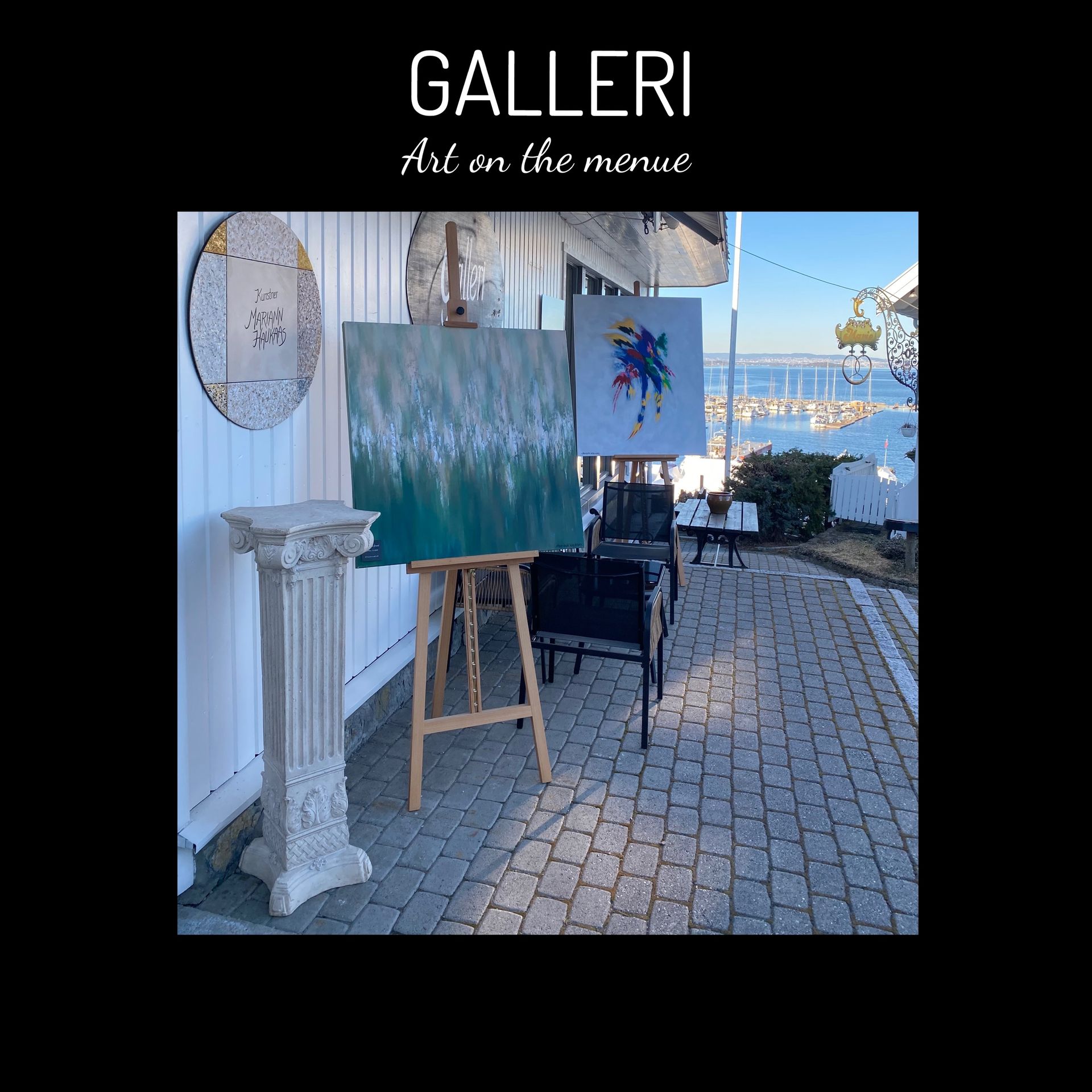 A painting is on an easel in front of a building.