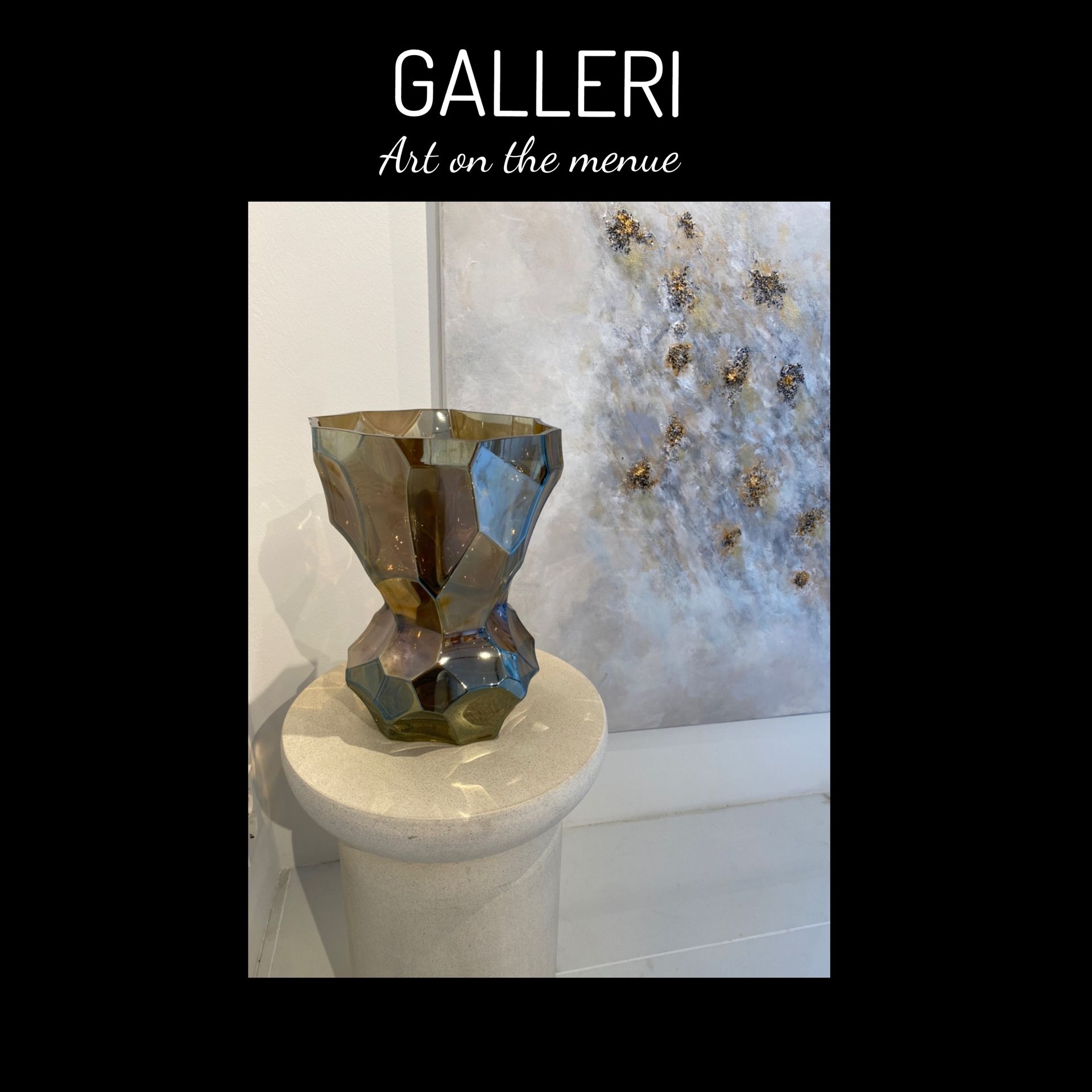 A sculpture is sitting on a pedestal in front of a painting.