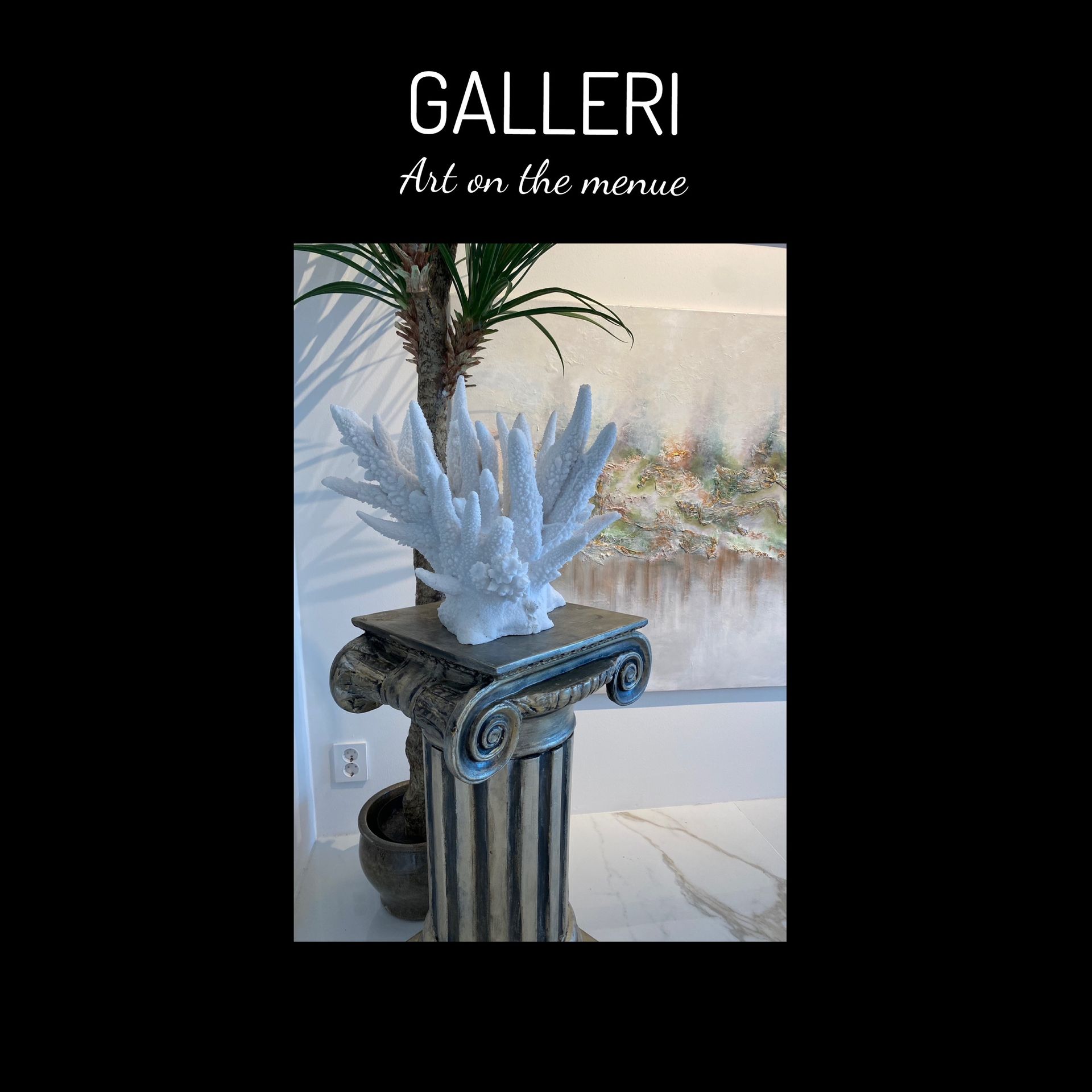 A statue of a coral is sitting on top of a pillar.